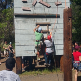 Participants start climbing the wall with the goal of ringing the bell at the top.